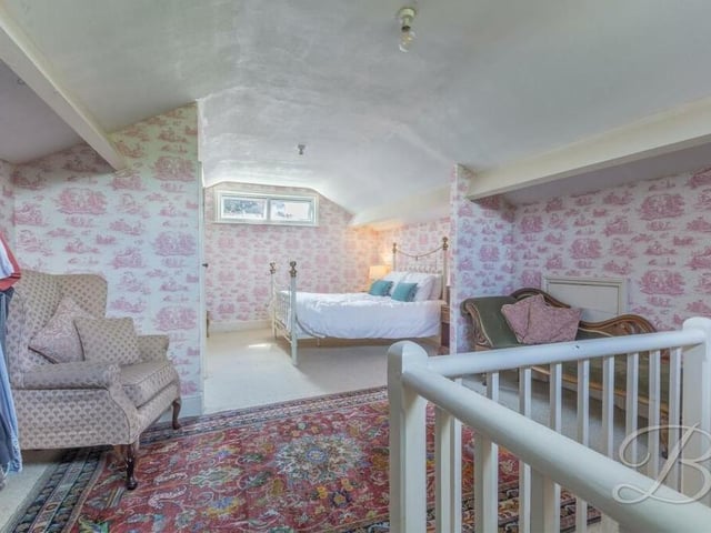 The Mansfield gem also has a second floor, which features this sixth bedroom in the roof. It includes fitted carpets, a fitted wardrobe and windows to the front and back of the property.
