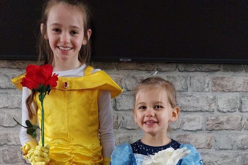 Ivy, eight, as Belle, and Ada, three, as Cinderella.