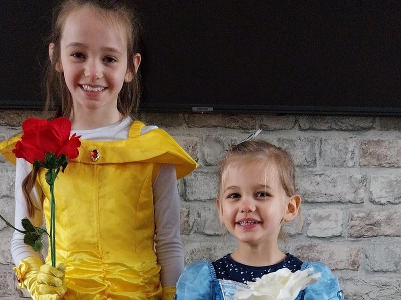 Ivy, eight, as Belle, and Ada, three, as Cinderella.