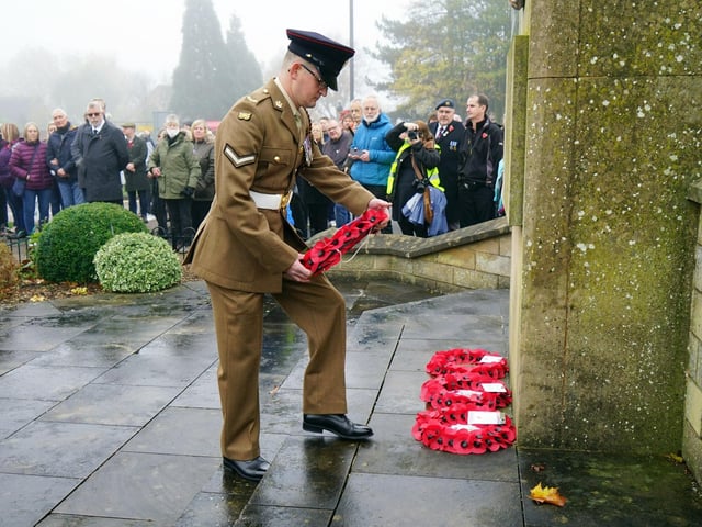 Members of the uniformed service laid wreaths at the war memorial