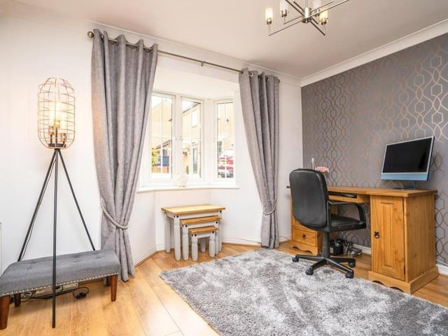 This room, with a double-glazed bay window overlooking the front of the house, could be used as an office or study.
