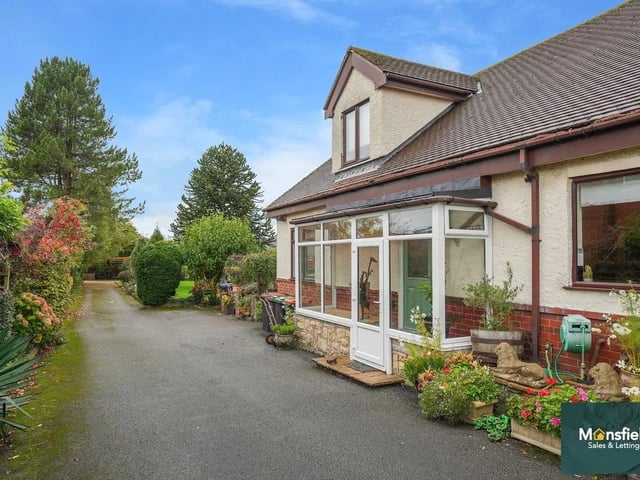 The home offers impressive kerb appeal with electric gated access leading to a sweeping driveway that continues around to the rear, providing extensive off-street parking for several vehicles, motorhomes, or caravans.