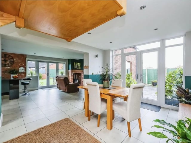 The open plan living/ dining room with vaulted ceiling and views over the garden is the perfect place for hosting dinner parties