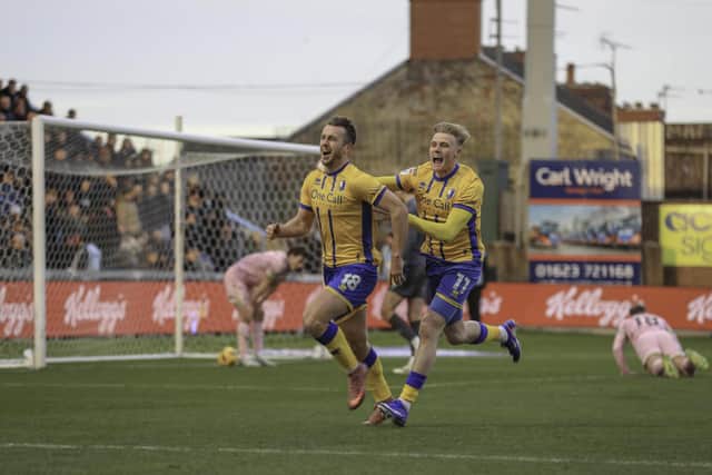Mansfield Town forward Rhys Oates celebrates his first half goal with team mate Will Evans, during the Sky Bet League 1 match against Bradford City AFC at the One Call Stadium, 01 Jan 2026. Photo credit, Chris & Jeanette Holloway / The Bigger Picture.media