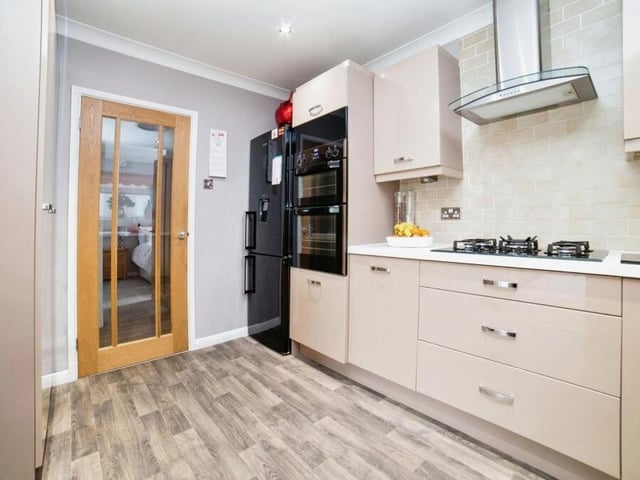 Another shot of the kitchen, showing appliances that include hob, ovens and modern fridge freezer.