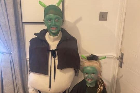 Alice, age 4, and Harley, age 10, from Mansfield, dressed as Shrek and Fiona.