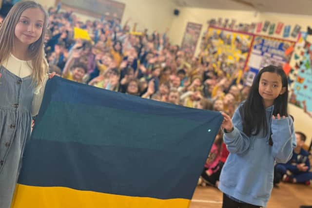 Ellie Wilkinson and Annamay Vu , both 10, hold up the Ukraine flag in front of children St Edmunds CofE Primary and Nursery School





“We all want peace in this world. We hope that all the money we have raised will make a difference in helping Ukrainian families.”