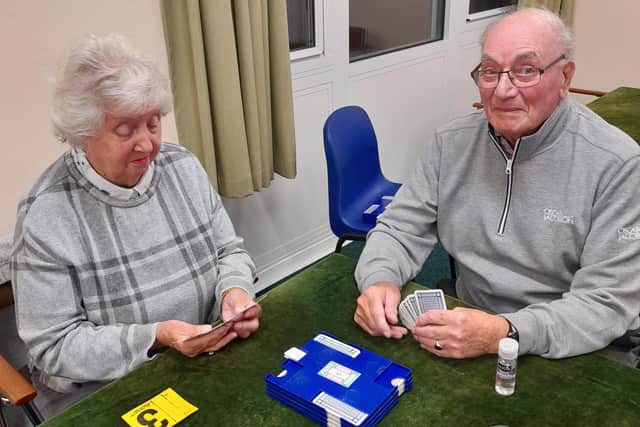 Checking their cards are two stalwarts of the bridge club, Tom and Jean Richardson, who have been married for 65 years. Tom is 90 and Jean celebrates her 90th later this year.