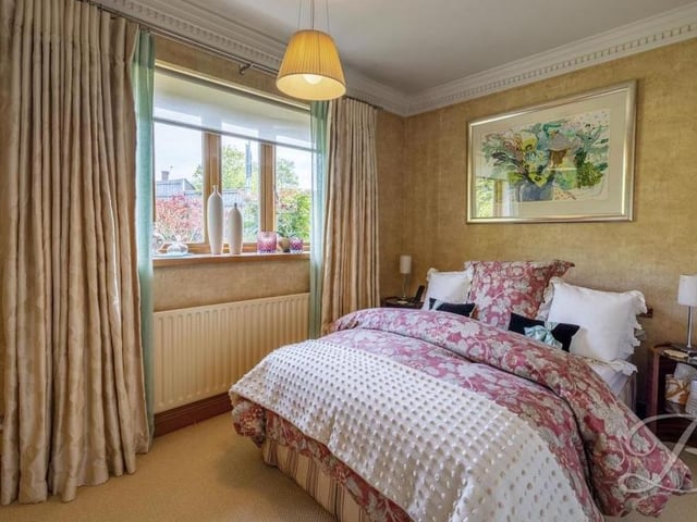 The second bedroom on the ground floor is the epitome of elegance. It features a carpeted floor, a double-glazed bay window facing the side of the property and, just out of shot, a large, built-in wardrobe.