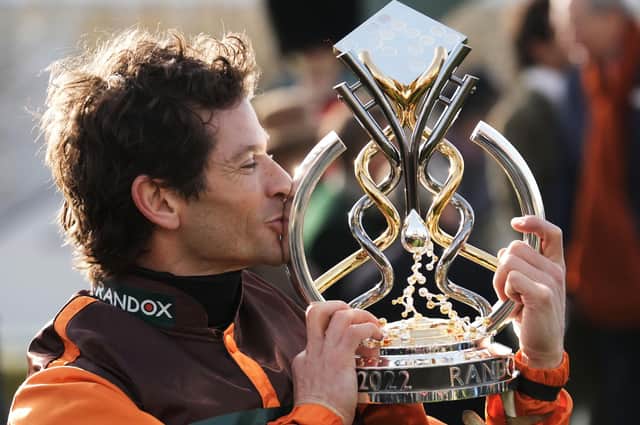 Amateur jockey Sam Waley-Cohen gives the trophy a kiss after winning last year's Grand National on 50/1 novice Noble Yeats in the last ride of his career.