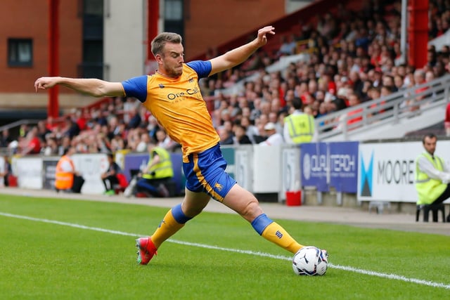Rhys Oates keeps the ball in play at full stretch at Leyton Orient.