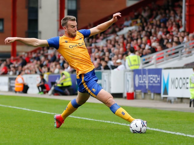 Rhys Oates keeps the ball in play at full stretch at Leyton Orient.