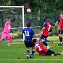 Will Norcross (10) curls the winner into the top corner of the net to give Sherwood Colliery 3 points. Pic: Dave Porter
