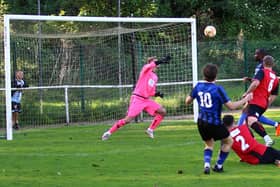 Will Norcross (10) curls the winner into the top corner of the net to give Sherwood Colliery 3 points. Pic: Dave Porter
