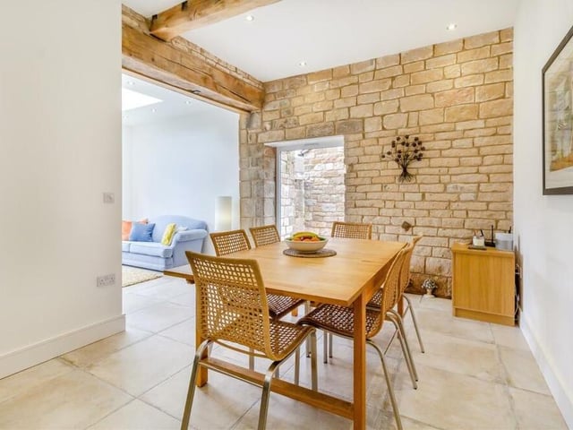 This exposed stone wall in the dining area is one of many original character barn features that can be found throughout the Mansfield Woodhouse property.