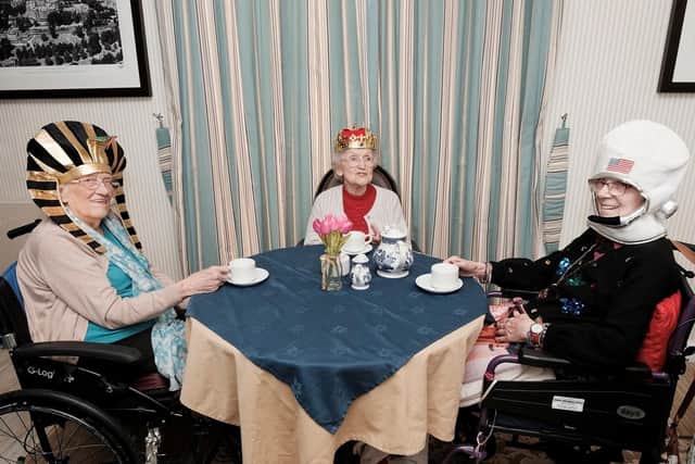 Residents Violet Huddard, June Hope and Sylvia Heys enjoying their history themed afternoon tea together.