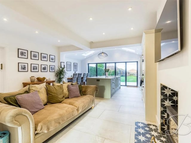 The Kitchen/diner leads to the additional seating area, which has a feature fireplace and a wealth of light from the open plan design.