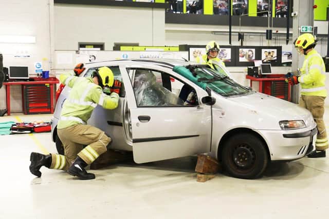 Fire fighters put protective screens in place before the extrication