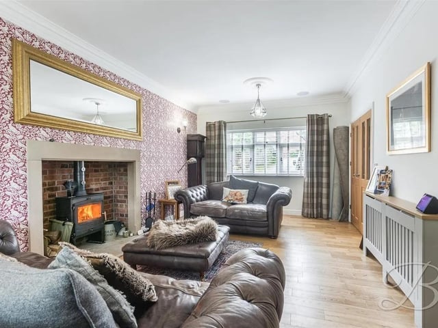 The living room is a warm and inviting space that also open onto the garden, creating a seamless connection to outdoor living.