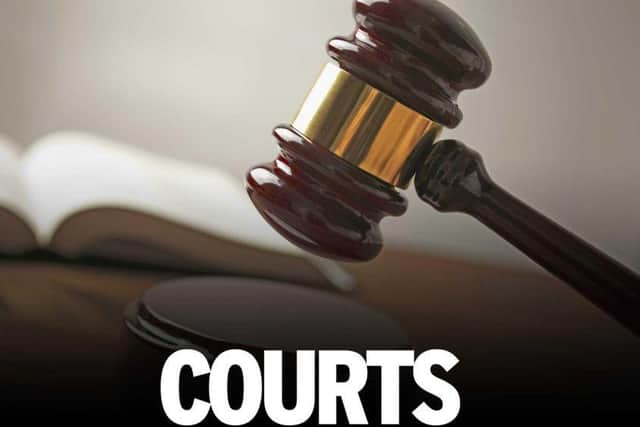 A Mansfield Woodhouse woman brandished a knife and cut someone's hand after a gang of people barged into her home, a court has heard.