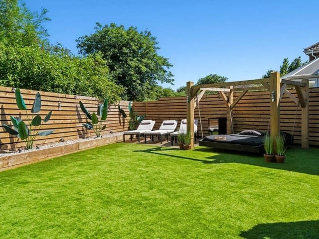Let's step outside now and find another corner of the rear garden. Imagine relaxing here in the summer sunshine.