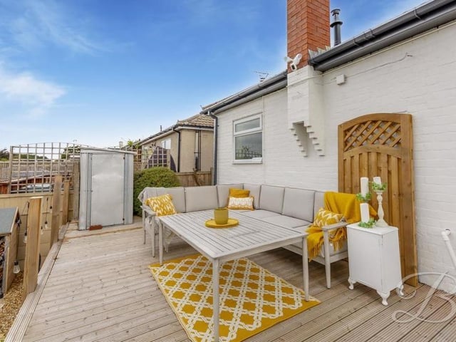 The top tier of the back garden houses this pleasant, decked seating area. A lovely spot for relaxing in the summer.