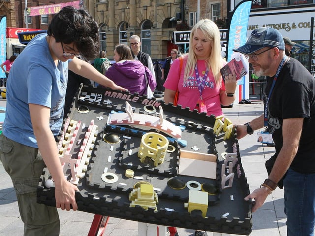 Visitors and organisers playing The Actual Reality Arcade in Mansfield town centre.