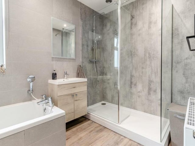 A second shot of the family bathroom, with its separate walk-in shower enclosure, fitted with a rainfall shower, plus an additional shower attachment.