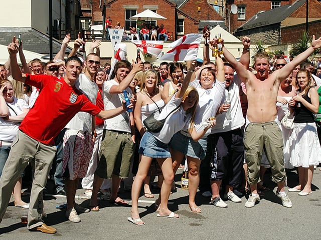England fans celebrate in the sun as they watch England's opening game of the 2006 World Cup at The Swan.