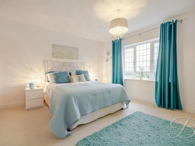 The bungalow boasts four spacious bedrooms, two of which have convenient access to the bathrooms.