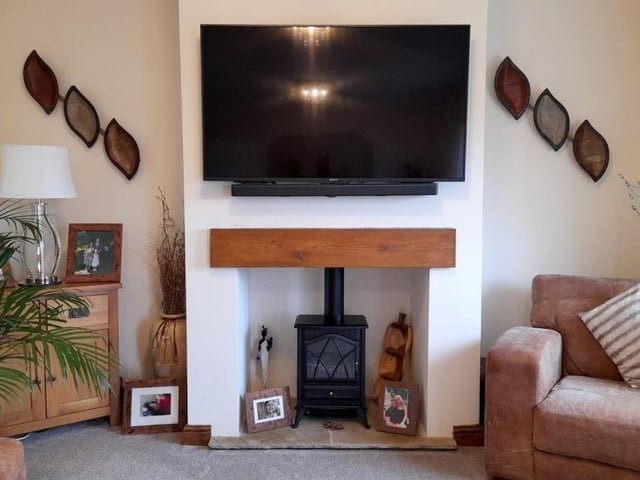 The fireplace in the lounge is an attractive asset . The hearth is made of Indian sandstone, while the wooden mantelpiece completes its look.