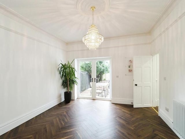 This ground-floor space is designated as a dining room but could also be used as a play room. Features include a picture rail and coving, while French doors lead out to the garden.