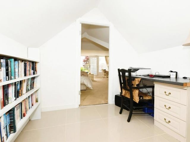 Just off the landing is this mezzanine study area overlooking the reception hall. It has a porcelain tiled floor and a door to the master bedroom.