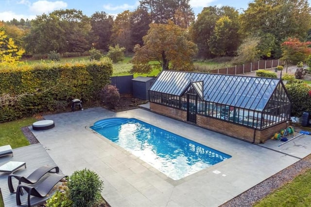 Two of the jewels in the crown of this property are the air-source heated swimming pool and the Victorian-style greenhouse, pictured in all their splendour here as part of an additional raised garden at the rear. A decked seating area lies by the pool, while the greenhouse has self-closing, temperature-regulating windows.