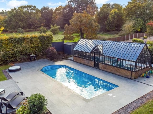 Two of the jewels in the crown of this property are the air-source heated swimming pool and the Victorian-style greenhouse, pictured in all their splendour here as part of an additional raised garden at the rear. A decked seating area lies by the pool, while the greenhouse has self-closing, temperature-regulating windows.