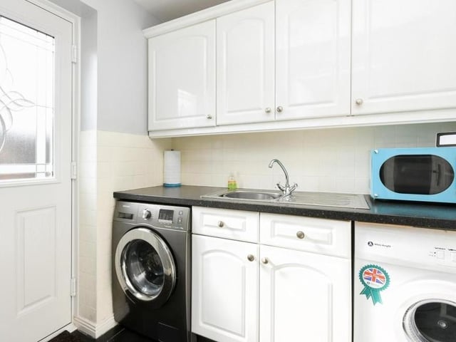 Attached to the kitchen is this very useful utility room. It offers yet more storage, plus space for a washing machine and tumble dryer. The door opens out onto the back garden.