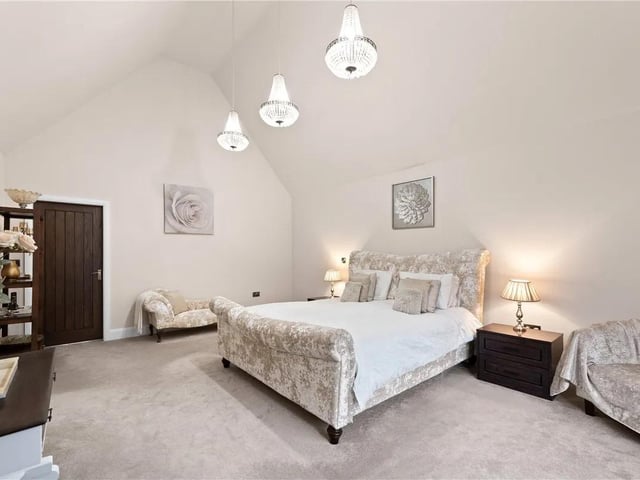 The master bedroom features a double glazed bay window to the front aspect, vaulted ceiling, doors leading to the en-suite and dressing rooms, carpeted flooring and a radiator.