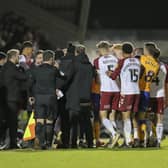 A touchline melee develops as Stephen Quinn is sent off at Sixfields. Photo by Chris & Jeanette Holloway/The Bigger Picture.media