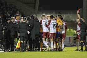 A touchline melee develops as Stephen Quinn is sent off at Sixfields. Photo by Chris & Jeanette Holloway/The Bigger Picture.media