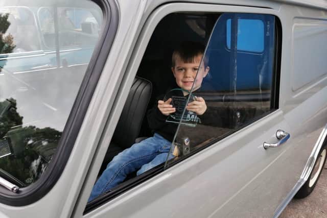 Kevin's son proudly holds the Masters of the Marque trophy awarded for his rare Mini Van