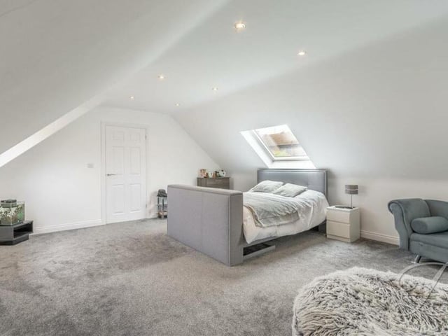 The second bedroom on the first floor of the £750,000 bungalow is also a terrific size. It boasts fitted carpets, a fitted wardrobe, two Velux windows, an additional window to the side of the property and downlights.