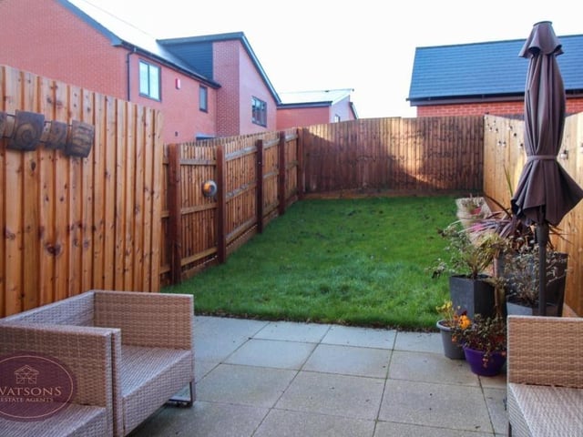 Let's take a quick look outside now. The rear garden boasts a well-maintained lawn and also a paved patio area for seating and entertaining.