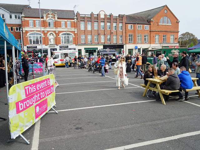 People enjoying the music - and an ice cream - during the day.