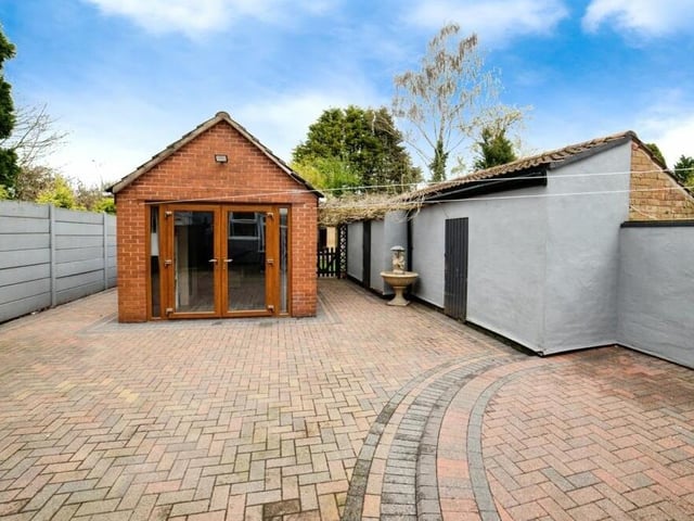 The highlight of the rear garden is undoubtedly this amazing 'man cave', a converted outbuilding with a fitted bar.
