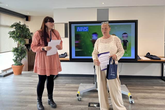 Cheryl Martins (right) received a certificate from work placement officer Sarah Ricketts.
