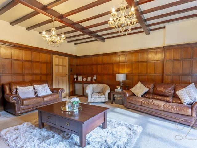 The living room is full of character, thanks largely to its bespoke oak panelling.