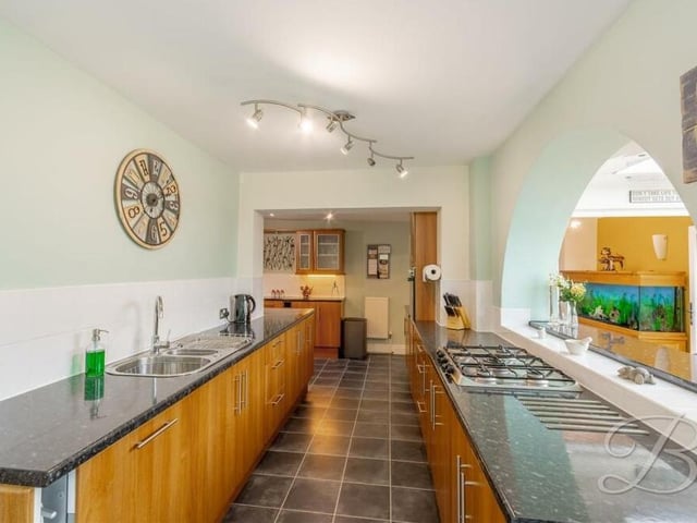 The first of three photos inside the superbly appointed kitchen, which features a gas hob and an inset stainless steel sink and drainer.