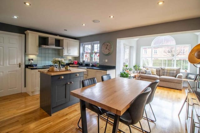 At the heart of the property is this kitchen/breakfast room, which has ample space for a table and chairs. There is oak flooring throughout, and its open-plan layout means it eases seamlessly into the garden room (background).