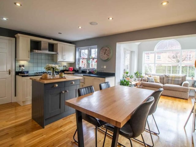 At the heart of the property is this kitchen/breakfast room, which has ample space for a table and chairs. There is oak flooring throughout, and its open-plan layout means it eases seamlessly into the garden room (background).