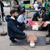 Demonstrating how to deliver CPR and use a defibrillator